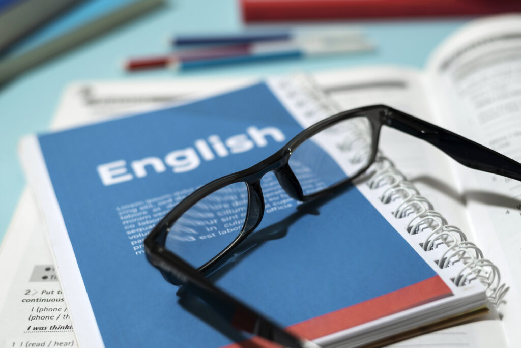 Picture of a glasses on an English notebook